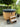 Tøbbe Hottub Ø 175 cm met thermocover op een betegeld terras in een zonnige tuin onder een boom – Hottub kopen voor optimaal comfort.